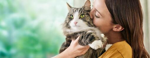 A woman kissing her cat